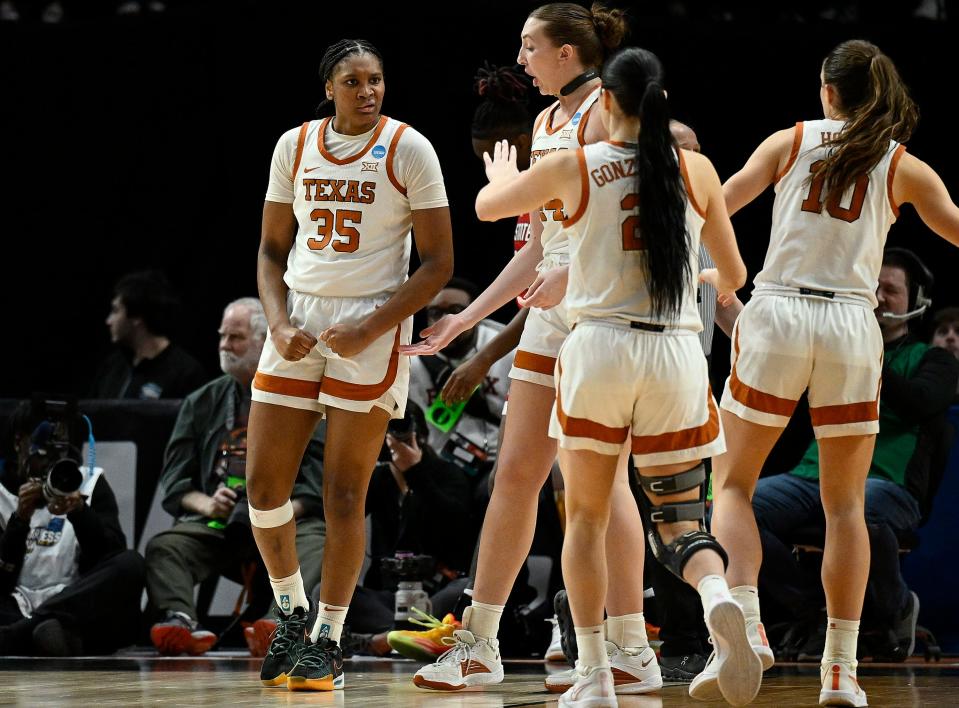 Texas forward Madison Booker, left, reacts after scoring a basket and getting fouled on the same play during the second period of Sunday's loss to North Carolina State in the Elite Eight of the NCAA Tournament. The No. 1-seeded Longhorns should return all but two players in their regular rotation, and they'll get star point guard Rori Harmon back as well.