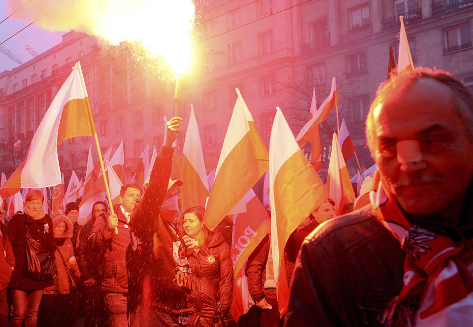 Marchers burn flares during the annual March of Independence organized by far right activists to celebrate 100 years of Poland's independence marking the nation regaining its sovereignty at the end of World War I after being wiped off the map for more than a century. (AP Photo/Alik Keplicz)