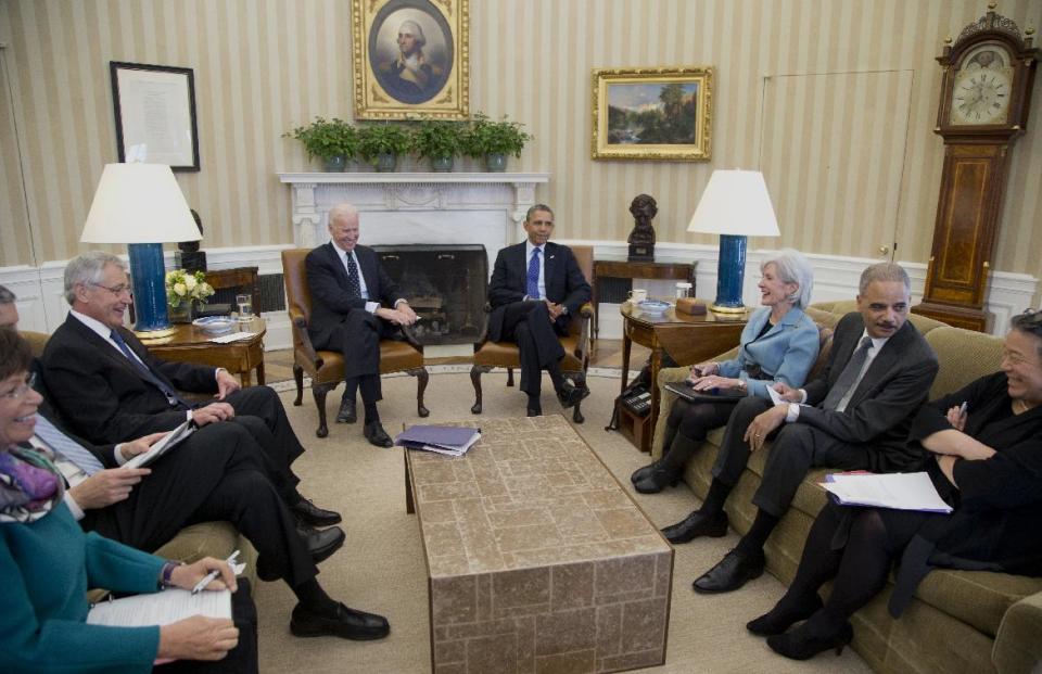 President Barack Obama and Vice President Joe Biden, center, meet with, from left, White House Senior Adviser Valerie Jarrett, Education Secretary Arne Duncan, Defense Secretary Chuck Hagel, Health and Human Services Secretary Kathleen Sebelius, Attorney General Eric Holder, and Executive Director of the White House Council on Women and Girls, Tina Tchen, who is also the Director of the White House Office of Public Engagement, in the Oval Office of the White House in Washington, Wednesday, Jan. 22, 2014, to discuss the Council on Women and Girls. (AP Photo/Carolyn Kaster)