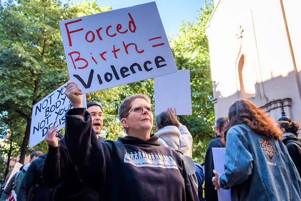 A protest sign that says "forced birth = violence"