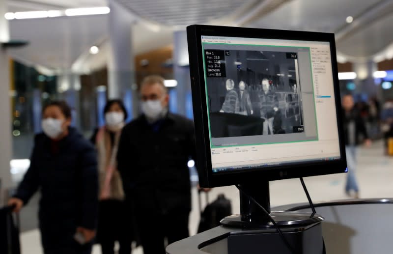 Passengers from China pass by a thermal screening point upon their arrival at Istanbul International Airport in Istanbul