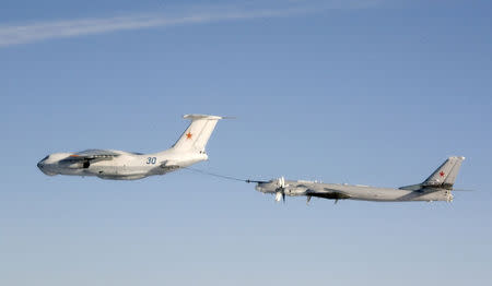 An undated handout photo provided by the Norwegian Army shows a Russian Tupolev Tu-95 strategic bomber refuelling from a Ilyushin IL-78 air-to-air refuelling tanker aircraft over an unknown location during a military exercise. . REUTERS/Norwegian NATO QRA Bodø/Handout