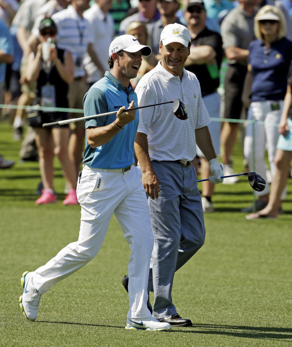 Rory McIlroy, of Northern Ireland, walks with Jeff Knox, right, down the eighth fairway during the third round of the Masters golf tournament Saturday, April 12, 2014, in Augusta, Ga. (AP Photo/Darron Cummings)