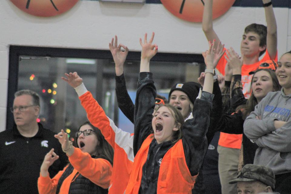 The Mackinaw City student section celebrates after senior Cooper Whipkey connected on a 3-pointer during the first half against Harbor Light on Tuesday.
