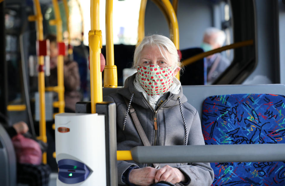 27 April 2020, Mecklenburg-Western Pomerania, Rostock: A woman is sitting in a bus with a self-made mouthguard as mouth and nose cover. From 27.04.2020 it is mandatory in Mecklenburg-Vorpommern to wear a mouth and nose cover when shopping and in public transport including taxis. Photo: Bernd Wüstneck/dpa-Zentralbild/dpa (Photo by Bernd Wüstneck/picture alliance via Getty Images)