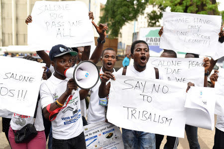 Active Youth for Sustainable Change, a student advocacy group, campaign for peaceful elections outside the high court in Freetown, Sierra Leone March 26, 2018. REUTERS/Olivia Acland