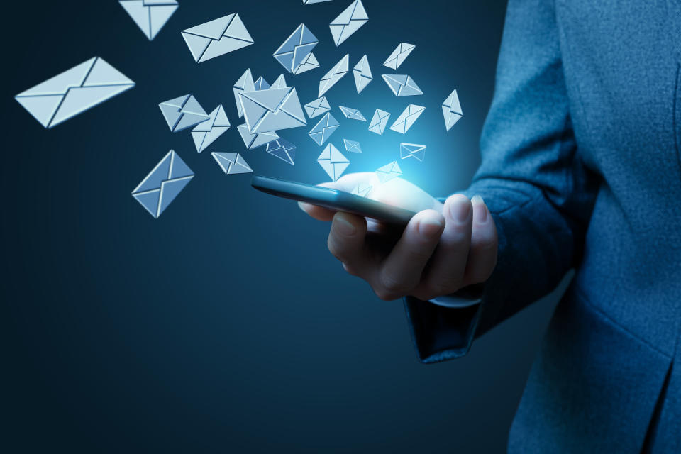 Businesswoman works with emails on a blue background.