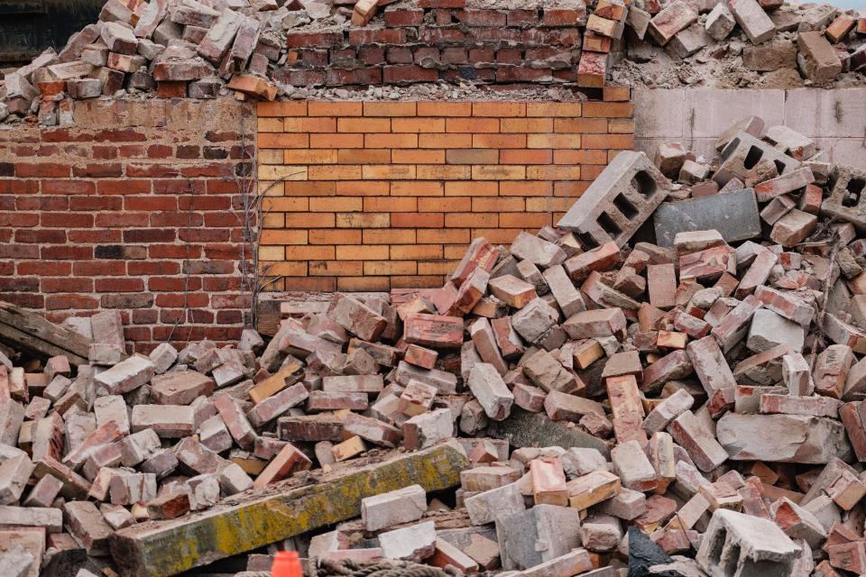 Different eras of brick-work can be seen among rubble being cleared from the demolition of the former Tuscarawas Valley Brewing Company, Thursday, Jan. 4 in Dover.