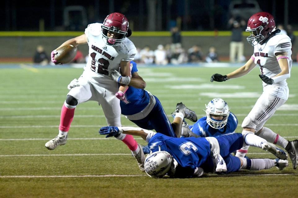 Santa Paula's Allen Macias leaps over a Fillmore defender during the teams' Citrus Coast League game at Fillmore High on Friday, Oct. 28, 2022. Fillmore won 35-28 to secure the outright league championship in the 112th meeting between the rival schools.