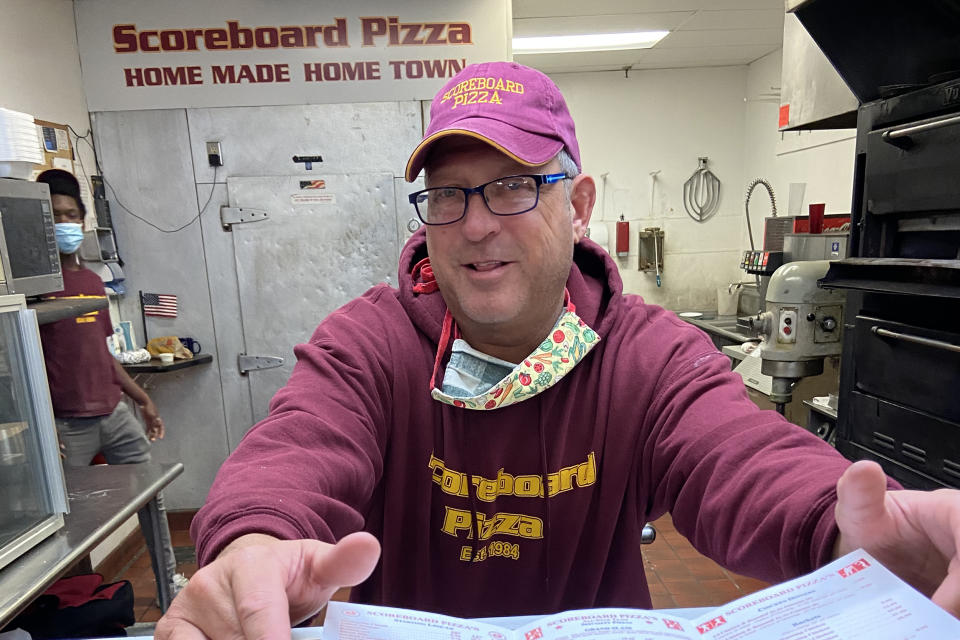 Image: Jim Johnson, owner of Scoreboard Pizza takes a pose. The pizzeria has been giving away free pizza (Deon J. Hampton / NBC News)