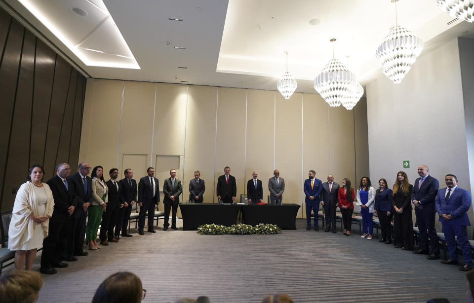 Representatives from the Venezuelan government, Mexican Foreign Minister Marcelo Ebrad, Norwegian diplomat Dag Nylander and Venezuelan opposition representatives pose for a photo during the signing of an agreement to create a U.N.-managed fund to finance health, food and education programs for the poor during a ceremony at a hotel in Mexico City, Saturday, Nov. 26, 2022. The agreement signed by representatives of Venezuelan President Nicolás Maduro and the opposition marked the resumption of long-stalled negotiations meant to find a common path out of their country's complex crisis. The U.S. government, in response, agreed to allow oil giant Chevron to pump Venezuelan oil. (AP Photo/Fernando Llano)