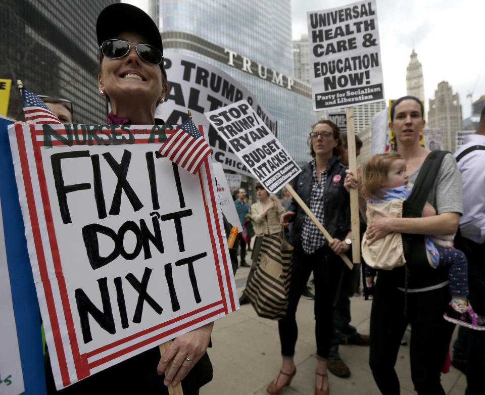 Protesters gather across the Chicago River from Trump Tower to rally against the repeal of the Affordable Care Act Friday, March 24, 2017, in Chicago. Earlier, President Donald Trump and GOP leaders yanked their bill to repeal "Obamacare" off the House floor Friday when it became clear it would fail badly. (AP Photo/Charles Rex Arbogast)