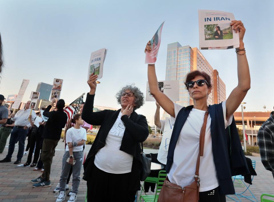 Protesters hold signs at a Thursday, Oct. 13, 2022, rally/demonstration in Oklahoma City to show support for the people of Iran.