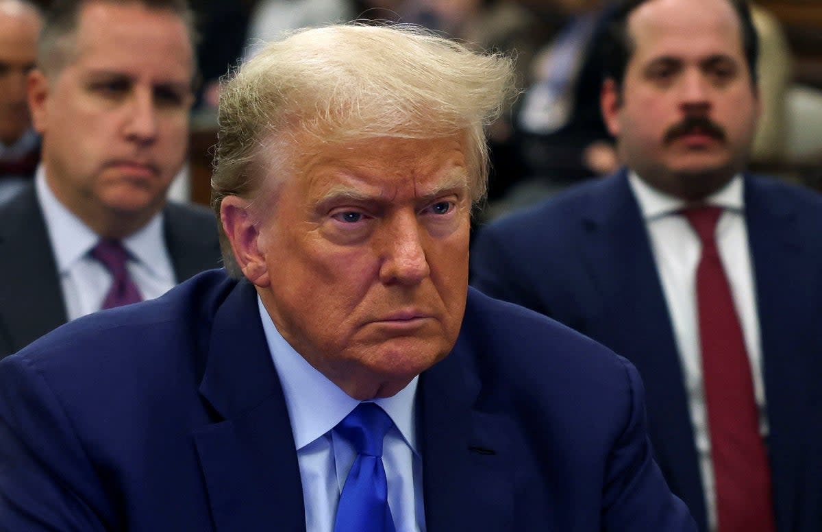 Donald Trump appears with his attorneys at the beginning of a fourth week of his civil fraud trial inside New York Supreme Court on 24 October. (REUTERS)