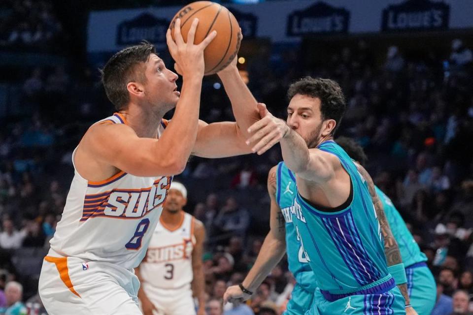 Mar 15, 2024; Charlotte, North Carolina, USA; Phoenix Suns guard Grayson Allen (8) shoots against Charlotte Hornets guard Vasa Micic (22) during the first quarter at Spectrum Center. Jim Dedmon/Jim Dedmon-USA TODAY Sports