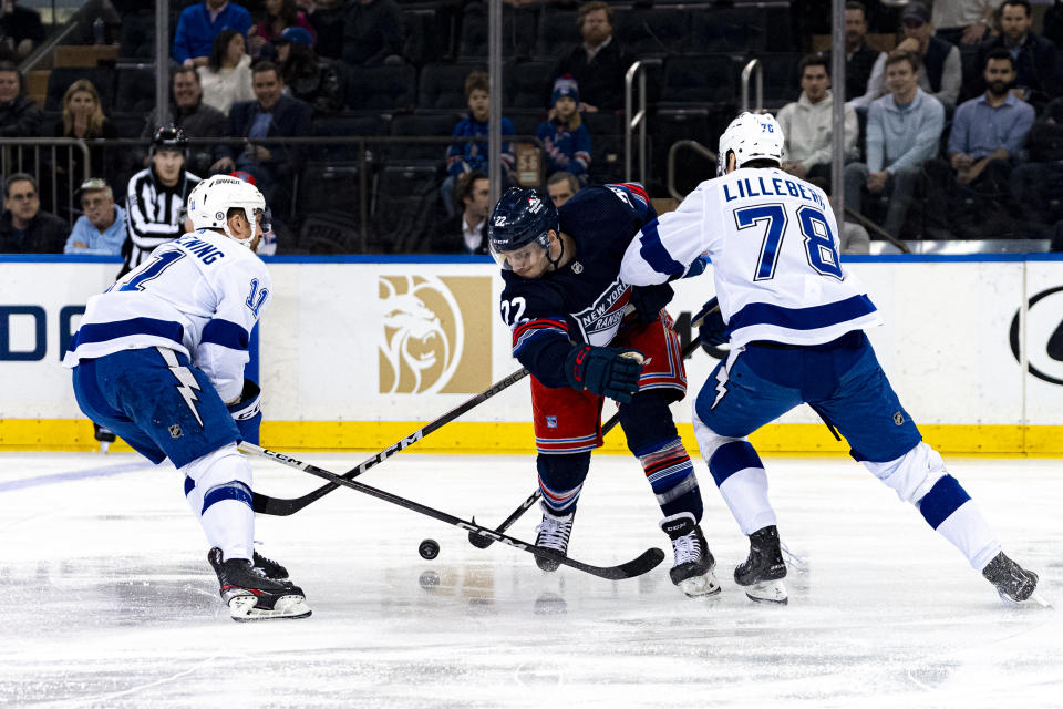 New York Rangers center Jonny Brodzinski (22) fights for the puck with Tampa Bay Lightning defenseman Emil Martinsen Lilleberg (78) and center Luke Glendening (11) during the first period of an NHL hockey game on Wednesday, Feb. 7, 2024 in New York. (AP Photo/Peter K. Afriyie)