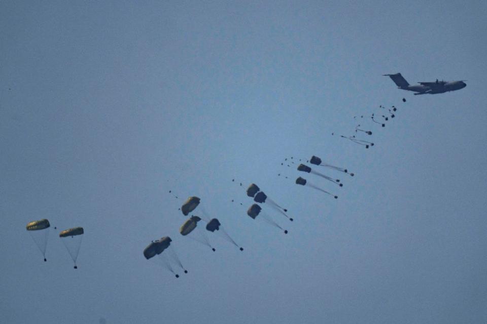 An aircraft airdrops humanitarian aid over Gaza the northern Gaza Strip, as seen from southern Israel, Friday, March 8, 2024.