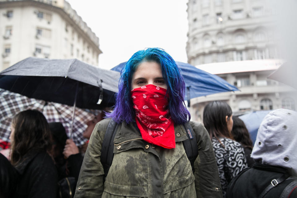 A woman protests in the rain in Buenos Aires.