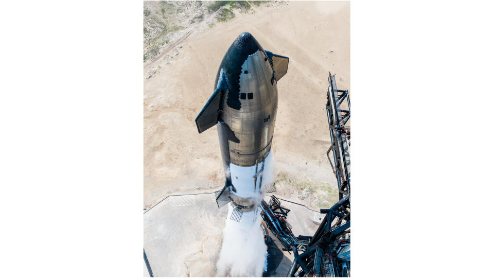 top-down view of a big silver rocket on a launch pad