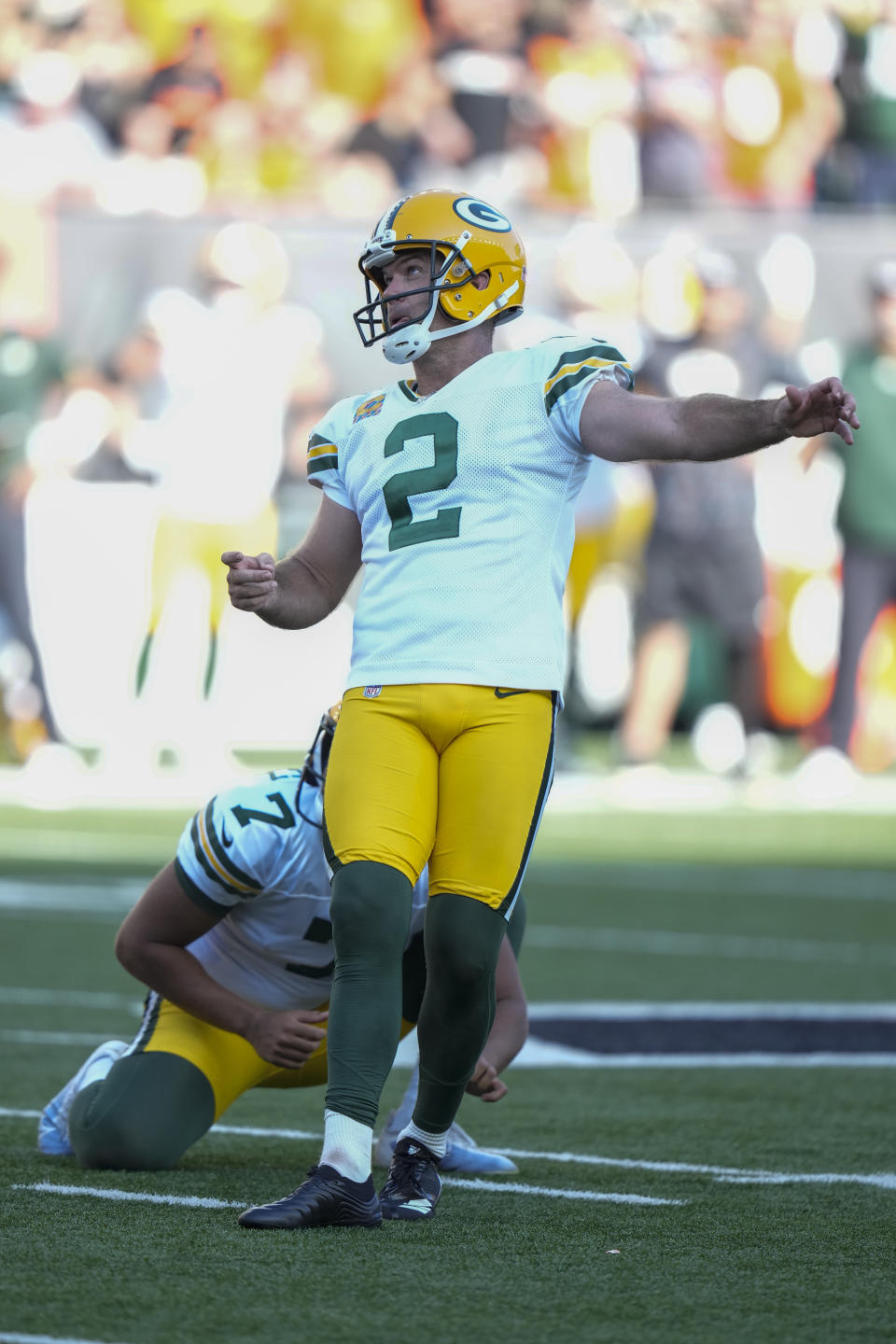 Green Bay Packers kicker Mason Crosby (2) kicks a winning field goal from the hold of Corey Bojorquez during overtime in an NFL football game against the Cincinnati Bengals in Cincinnati, Sunday, Oct. 10, 2021. (AP Photo/AJ Mast)