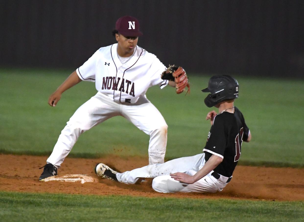 Oklahoma Union High School's Grant Reeves (10) slides safely into second base while Nowata's shortstop Adrian O'Dell (5) covers the base during baseball action in Nowata on April 8, 2024.
