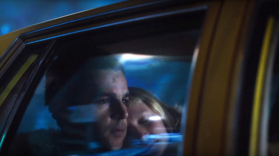 Christopher Abbott contemplates his next move while sitting next to a sleeping Mia Wasikowska in a yellow taxi in "Piercing"