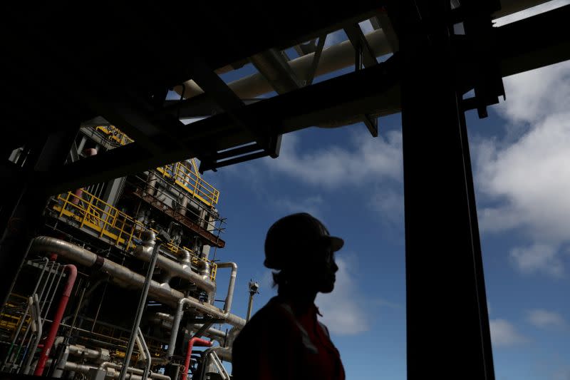 FILE PHOTO: A worker walks inside the Brazil's Petrobras P-66 oil rig in the offshore Santos Basin in Rio de Janeiro