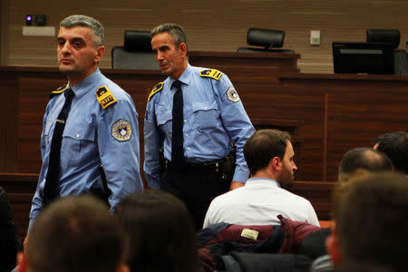 Frasher Krasniqi (R) parliament deputy of the biggest opposition party Vetevendosje appears in court in Pristina, Kosovo November 17, 2017, on trial for taking part in a grenade attack against the parliament building last year. REUTERS/Hazir Reka