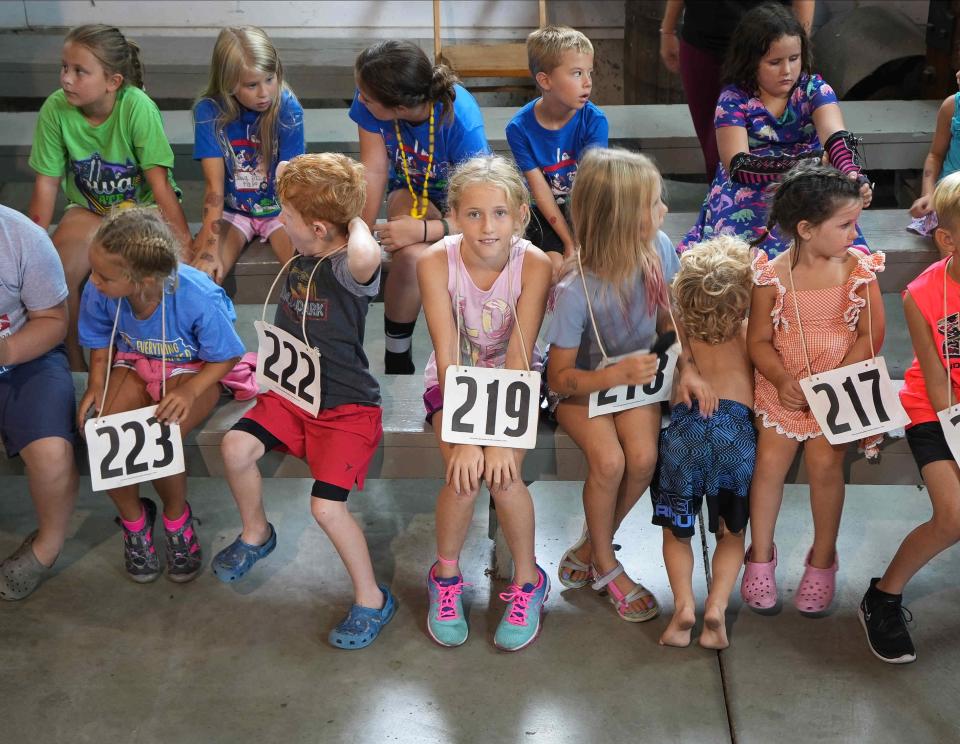 Young mom callers wait to participate in the mom calling event at Pioneer Hall at the Iowa State Fair in 2022.