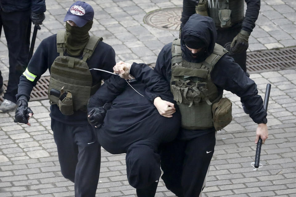 Police detain a man during an opposition rally to protest the official presidential election results in Minsk, Belarus, Sunday, Nov. 8, 2020. Club-swinging police went after demonstrators in the Belarusian capital who were demanding the resignation of the country's authoritarian president on Sunday, the 90th consecutive day of protests in the country. Human rights activists said nearly 400 people were arrested. (AP Photo)