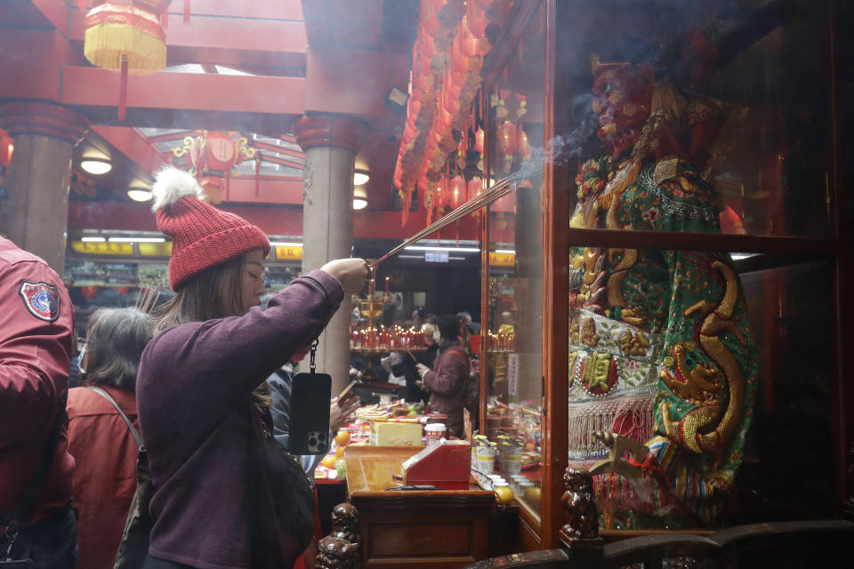 Worshippers go to pray at a temple on the first day of the Lunar New Year celebrations in Taipei, Taiwan, Saturday, Feb. 10, 2024. Each year is named after one of the 12 signs of the Chinese zodiac in a repeating cycle, with this year being the Year of the Dragon. (AP Photo/Chiang Ying-ying)