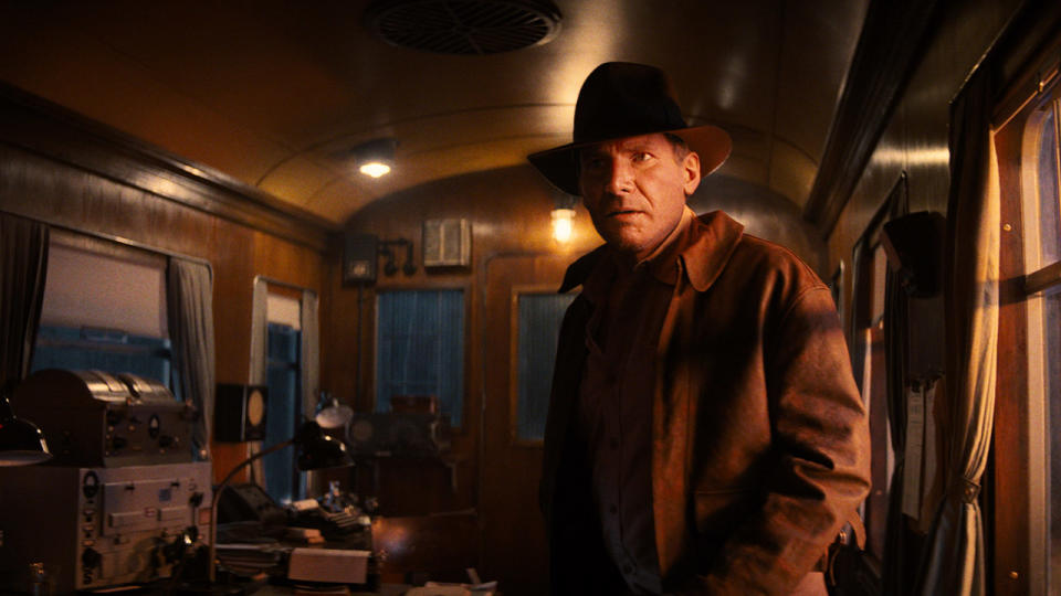 Still from the movie Indiana Jones and the Dial of Destiny. Here we see a younger Indiana Jones standing inside an old train carriage.