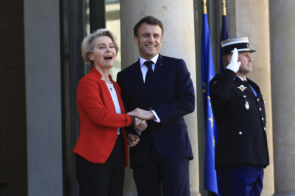 European Commission president Ursula van der Leyen smiles with French President Emmanuel Macron as she arrives for a working lunch, Monday, April 3, 2023 at the Elysee Palace in Paris. The two leaders will travel to China later this week. (AP Photo/Aurelien Morissard)
