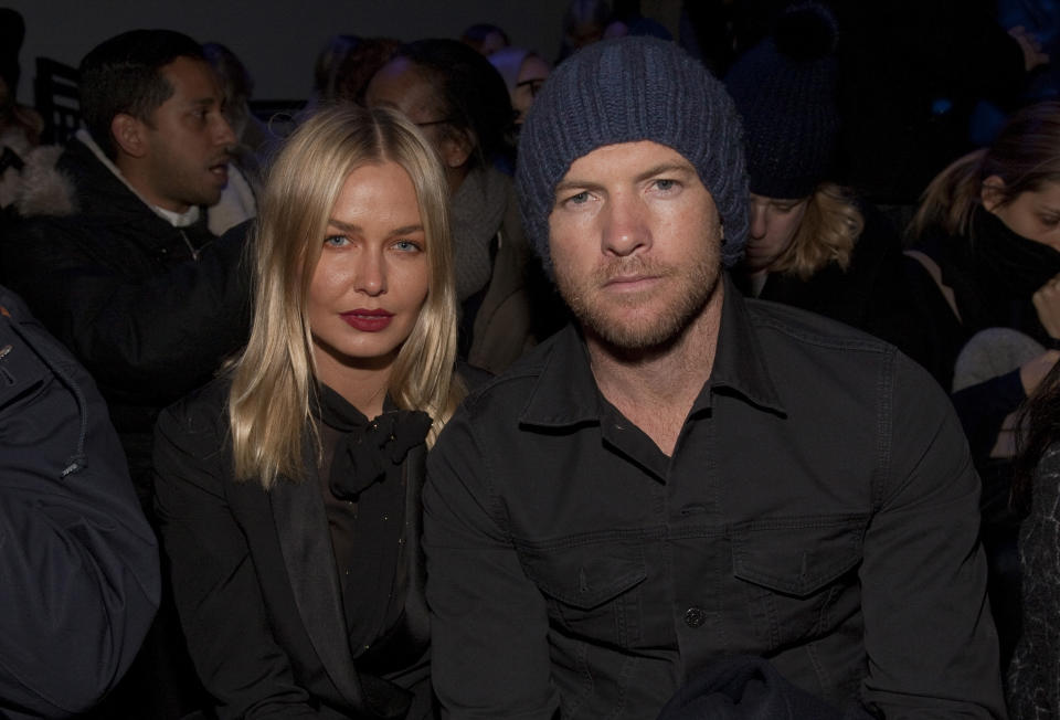 Fashion model Lara Bingle, left, and actor Sam Worthington, right, attend the MBFW 2014 Fall/Winter Alexander Wang fashion show, on Saturday, Feb. 8, 2014 in New York. (Photo by Andy Kropa/Invision/AP)