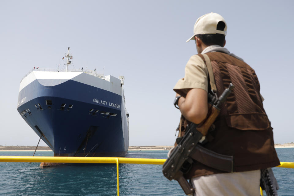 A Houthi soldier stands alert in front of the Israeli Galaxy ship which was seized by the Houthis, in the port of Saleef, near Hodeidah, Yemen, Sunday, May 12, 2024. (AP Photo/Osamah Abdulrahman)