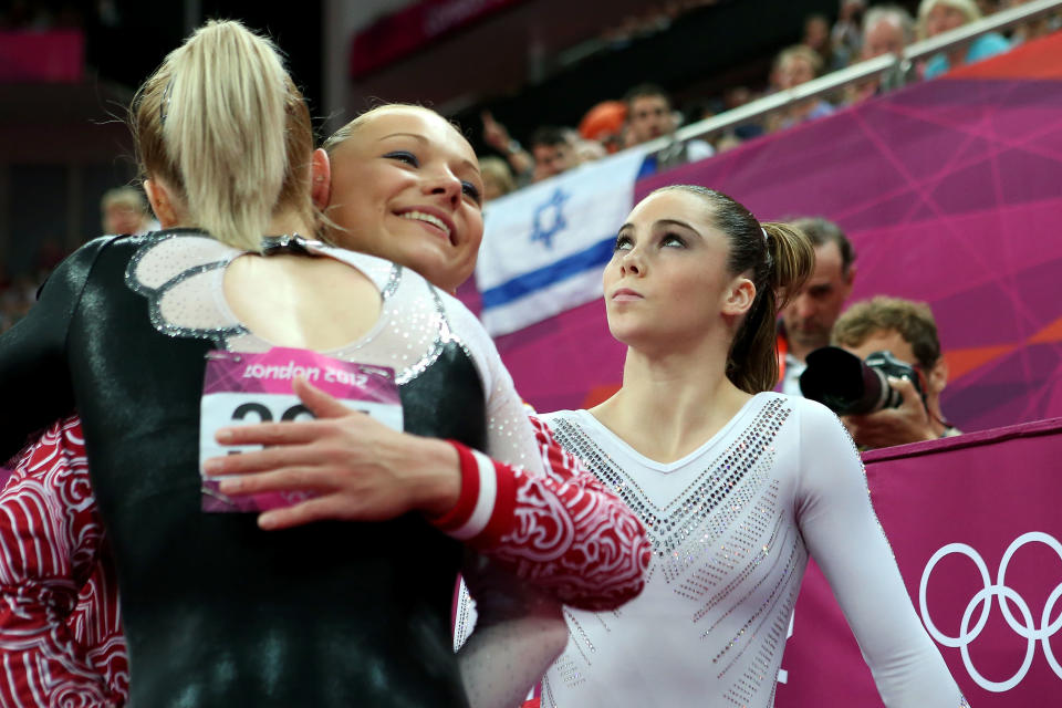 (L-R) Sandra Raluca Izbasa of Romania and Maria Paseka of Russia embrace as McKayla Maroney of the United States looks on during the Artistic Gymnastics Women's Vault Final on Day 9 of the London 2012 Olympic Games at North Greenwich Arena on August 5, 2012 in London, England. (Photo by Ronald Martinez/Getty Images)