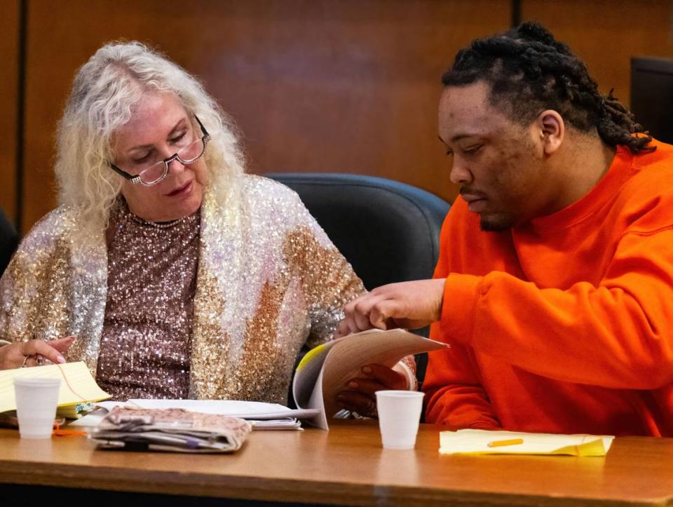 Murder suspect Dandrae Martin points to a section of a transcript with defense attorney Linda Parisi during testimony in a preliminary hearing in Sacramento Superior Court on Tuesday in the case of the April 2022 mass shooting in downtown Sacramento.