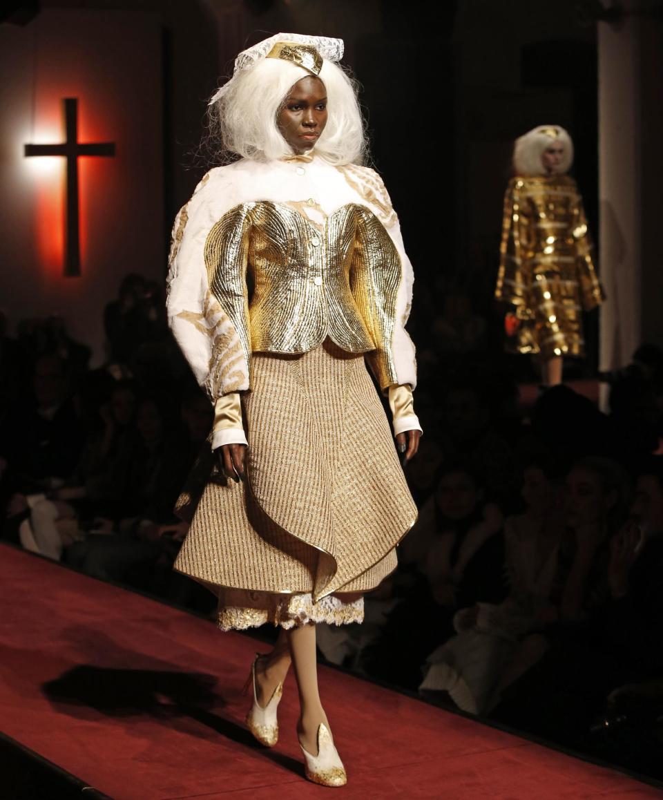 A model walks the runway during the presentation of the Thom Browne Fall 2014 collection in New York, Monday, Feb. 10, 2014. (AP Photo/Kathy Willens)