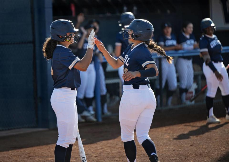 Central Catholic’s Jazmarie Roberts, left, and Taryn Calderon celebrate a run during the Valley Oak League game with Kimball at Central Catholic High School in Modesto, Calif., Tuesday, March 26, 2024. Central Catholic won the game 9-6.