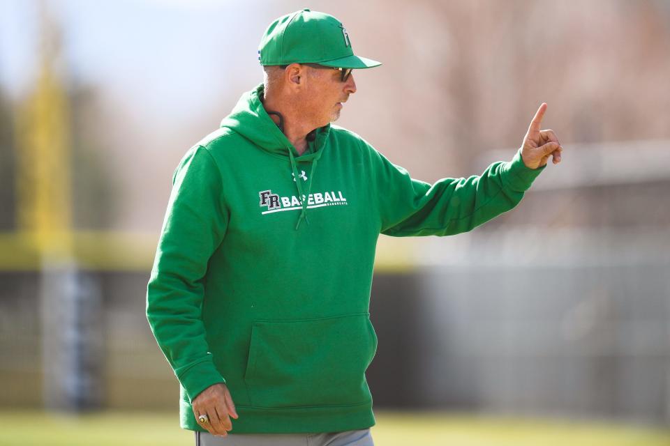 Fossil Ridge head coach Ted Bergquist walks toward the dugout after a meeting at the mound during a high school baseball game against Fort Collins at Fort Collins High School on Tuesday, April 18, 2023, in Fort Collins, Colo. The Lambkins won 2-1.