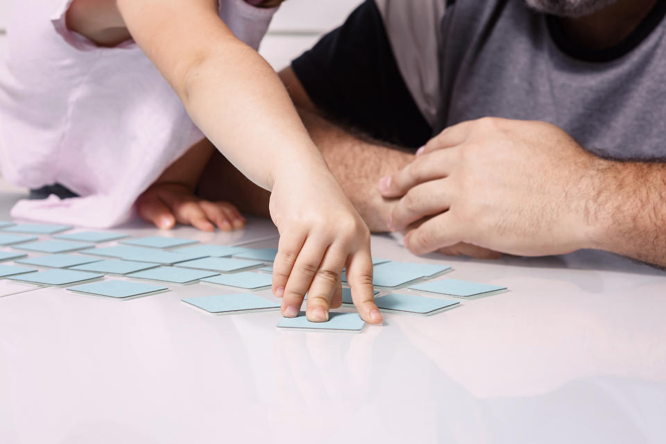 dad and little daughter play together. Memo cards for early childhood memory development