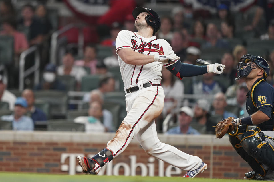 Atlanta Braves center fielder Adam Duvall (14) hits a single during the seventh inning of Game 4 of a baseball National League Division Series against the Milwaukee Brewers, Tuesday, Oct. 12, 2021, in Atlanta. (AP Photo/Brynn Anderson)