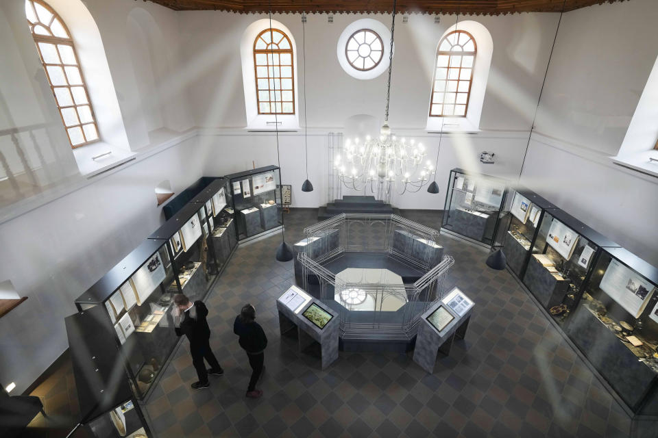 People visit an exhibition in the renovated synagogue in Wojslawice, Poland, Thursday Oct. 14, 2021. On Thursday a memorial was dedicated in Wojslawice to some 60 Jews executed in the town by Nazi German forces during their occupation of Poland during World War II. (AP Photo/Czarek Sokolowski)