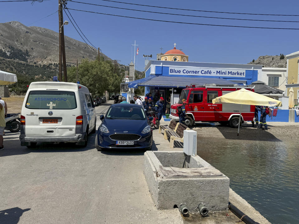 A view of an ambulance and a fire brigade van are on a beachfront of Symi island, Greece, Sunday, June 9, 2024. Police said that a body believed to be that of missing British TV presenter Michael Mosley was found on a Greek island Sunday morning. (AP Photo/Antonis Mystiloglou)