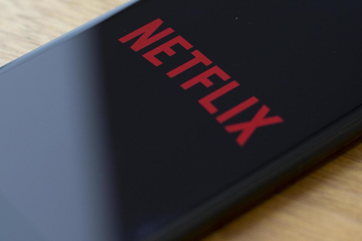 The Netflix logo is seen on a phone in Washington, DC, on 10 July, 2019 (file photo): ALASTAIR PIKE/AFP/Getty Images