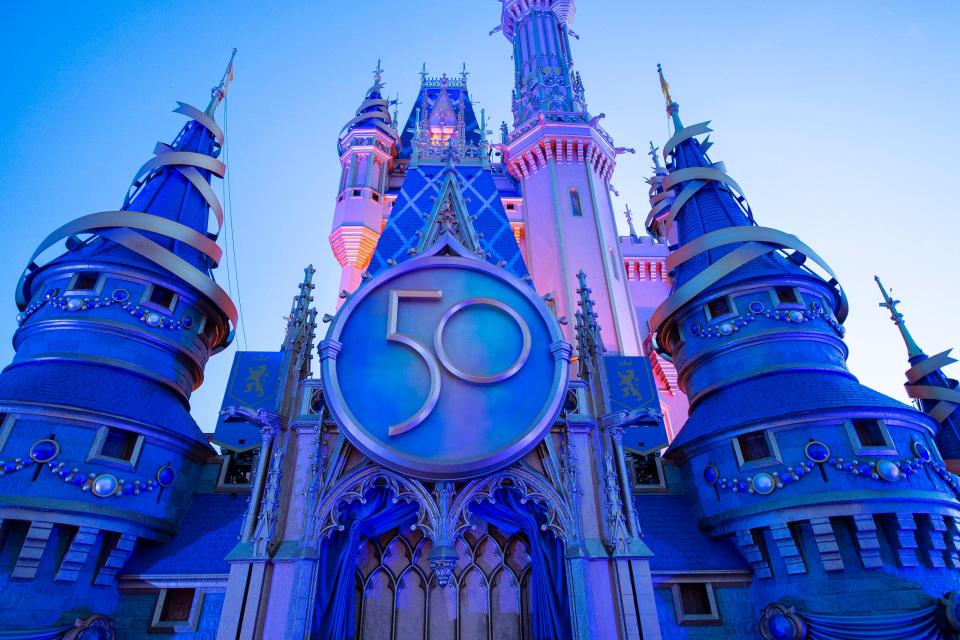 Cinderella's Castle gets a new crest to honor the 50th anniversary of Walt Disney World. An 18-month celebration kicks off Oct. 1.
