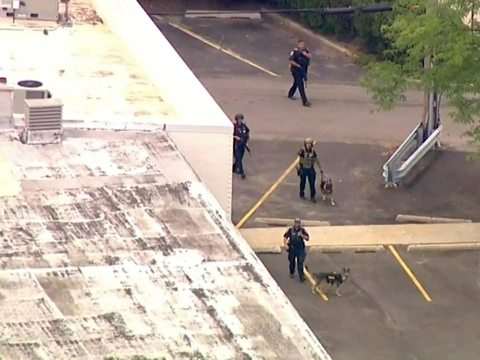 Police search an area after gunfire erupted at a Fourth of July parade route in the wealthy Chicago suburb of Highland Park, Illinois, U.S. July 4, 2022 in a still image from video.