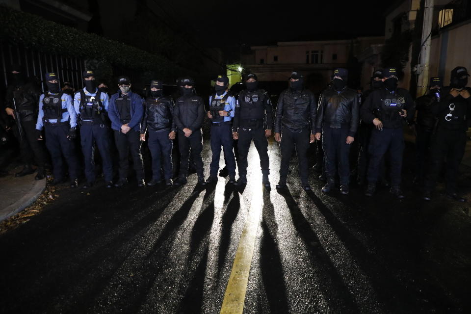 Special Forces Police block a street near the house of former Honduran President Juan Orlando Hernandez in Tegucigalpa, Honduras, late Monday, Feb. 14, 2022. After years of speculation in Honduras, the United States formally requested the arrest and extradition of Hernández less than three weeks after he left office. (AP Photo/Elmer Martinez)