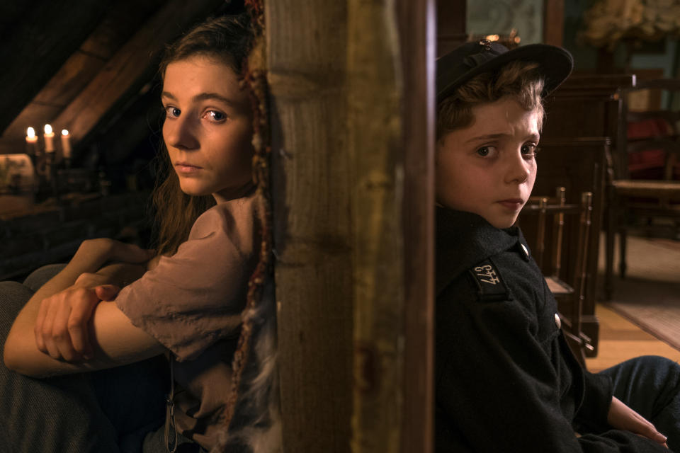 This image released by Fox Searchlight Pictures shows Thomasin McKenzie, left, and Roman Griffin Davis in a scene from the WWII satirical film "Jojo Rabbit." (Kimberley French/Fox Searchlight Pictures via AP)