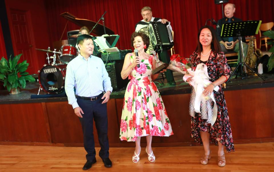 Ballroom dancing returned to the Roseland Ballroom in Taunton on Sunday, July 24, 2022. The venue will host ballroom dancing on the second and fourth Sunday of each month. Mikki Micarelli presents gifts of appreciation to Roseland Ballroom owners Philip Fei Pan and Linda Lin.